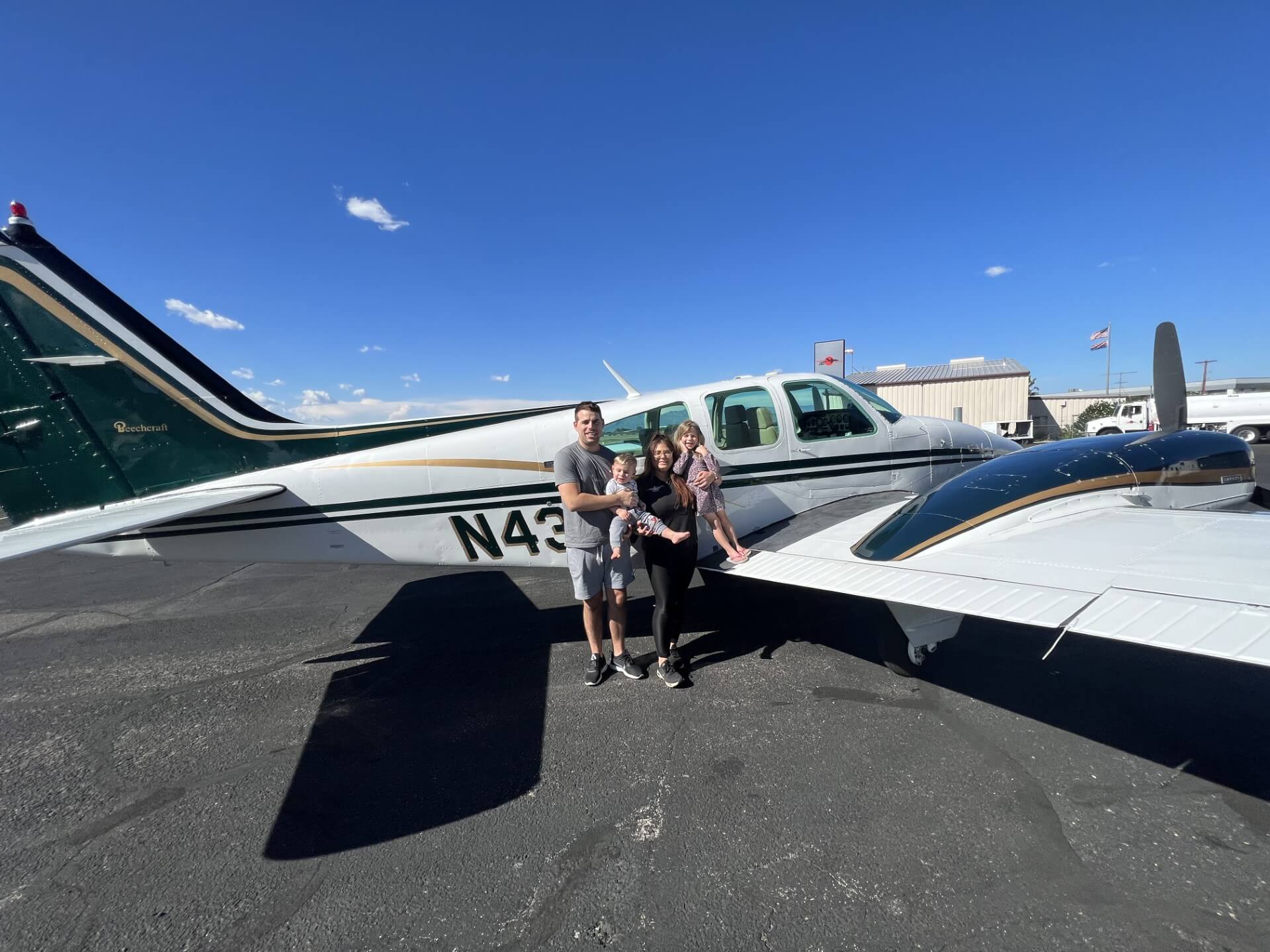 Sarah Tanis and her family standing in front of her plane. 
