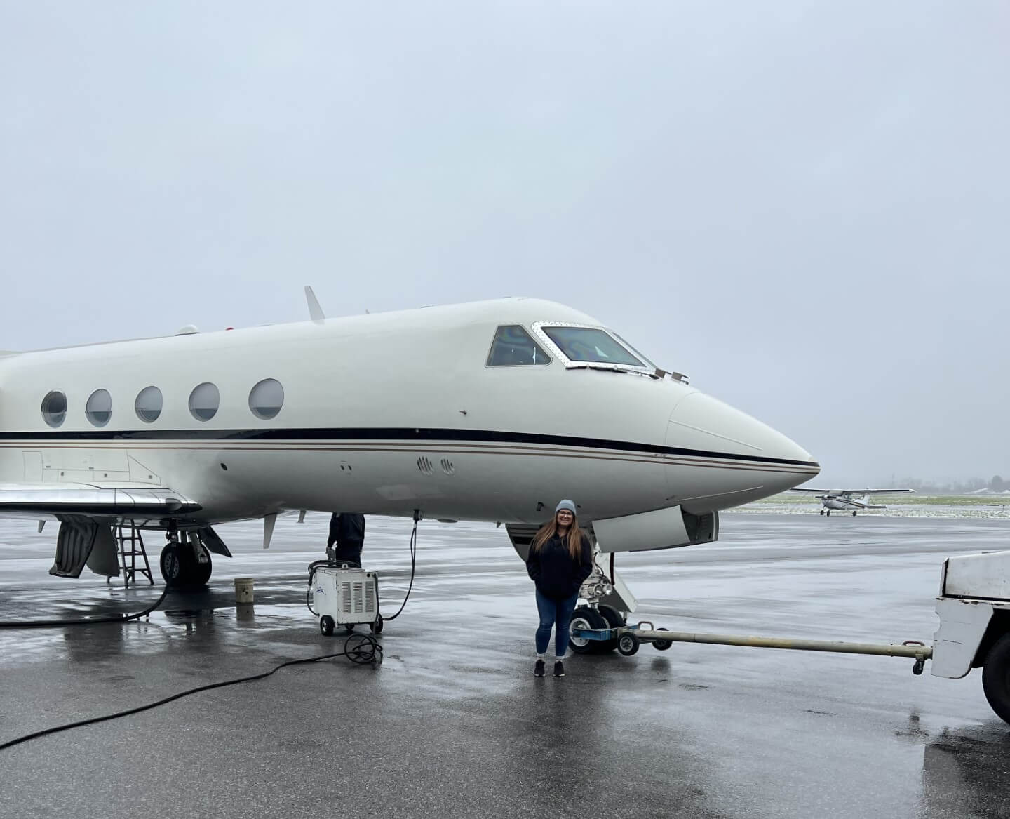 Sarah Tanis standing in front of Universal Avionics Gulfstream III